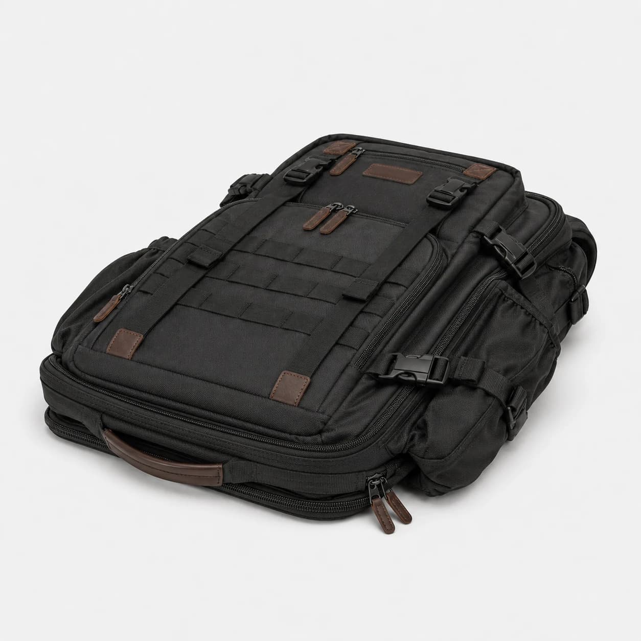 Black gear backpack laid flat to show its structured front panels, webbing, and zip compartments