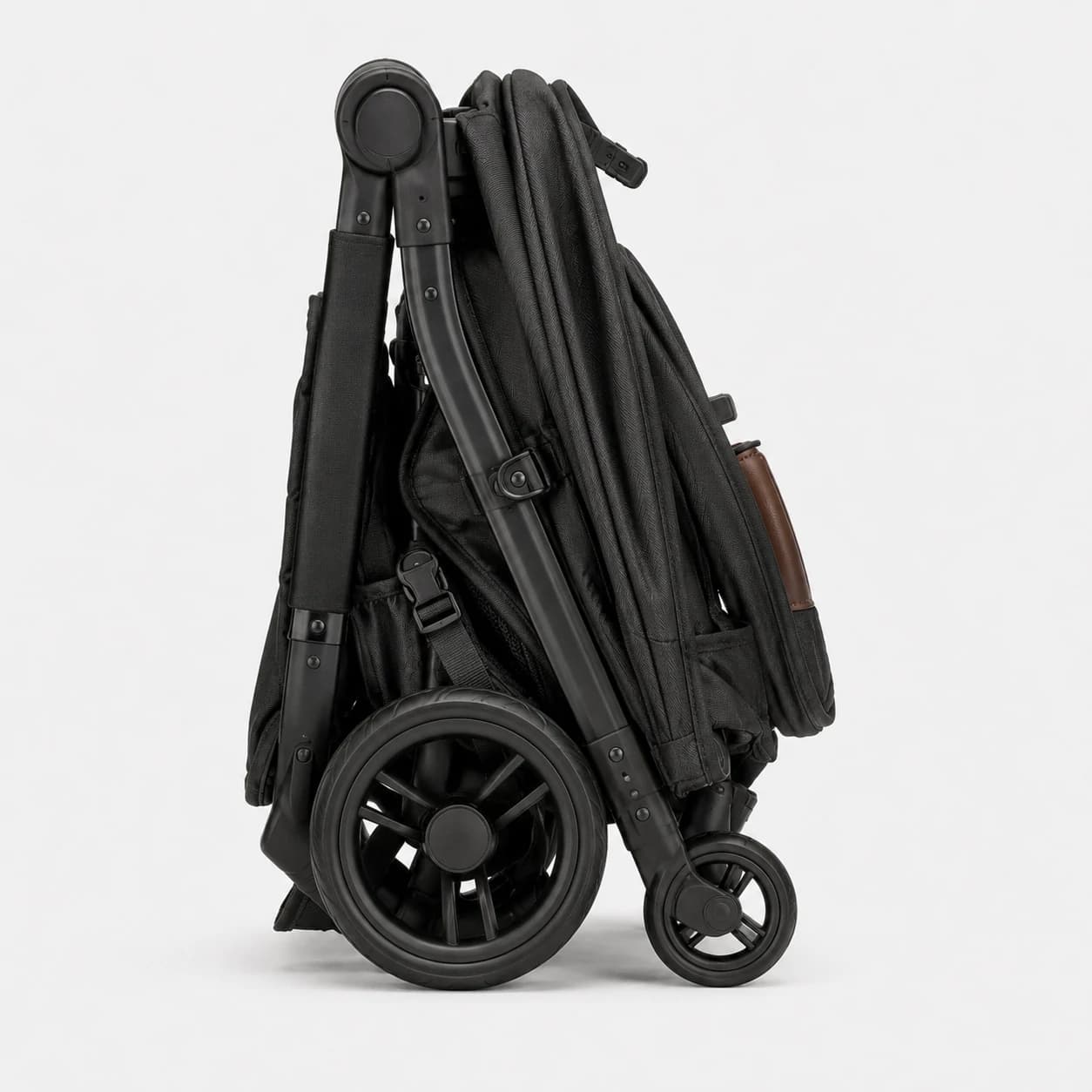 Black baby stroller folded into a compact upright travel position