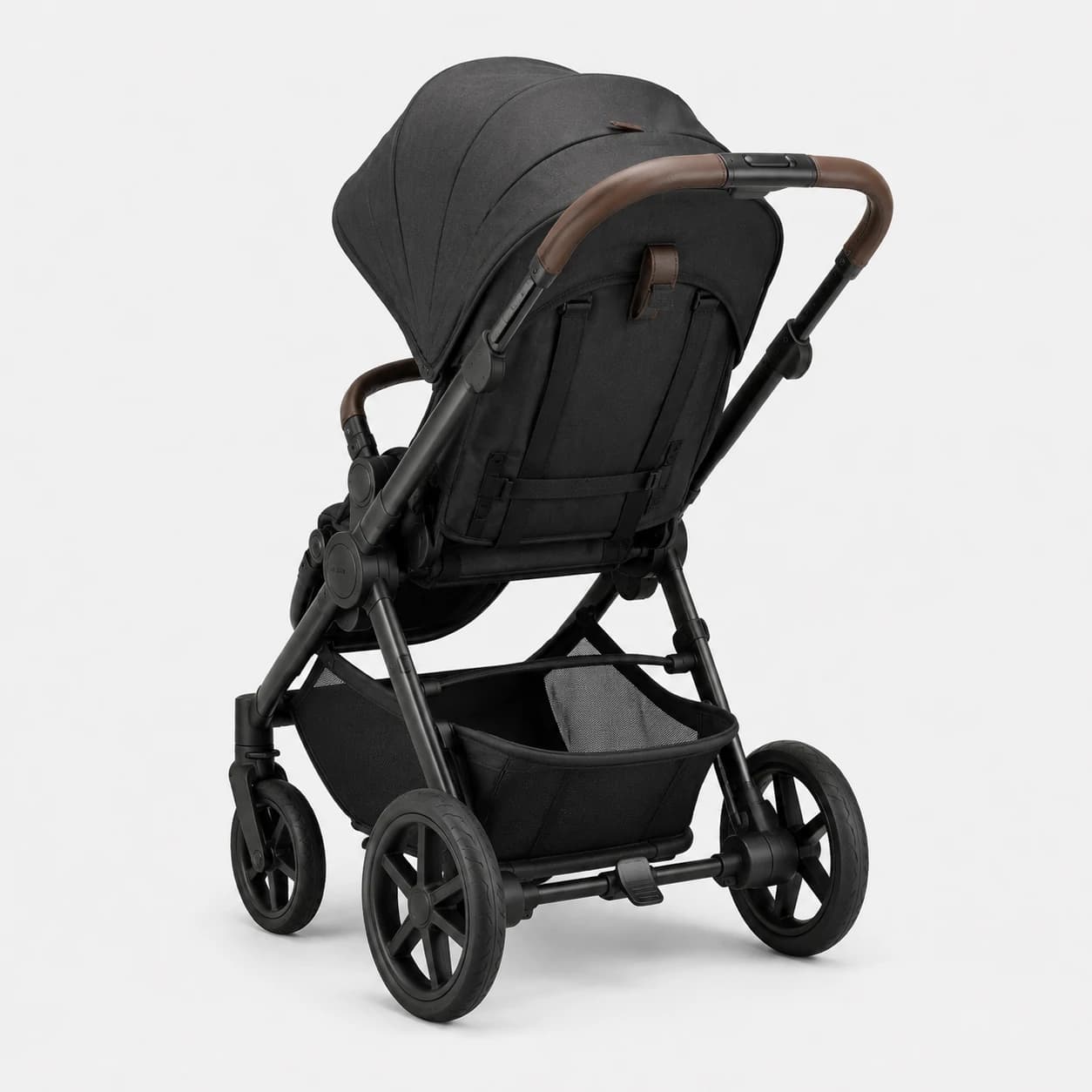 Rear three-quarter view of a black baby stroller with a brown handlebar and storage basket